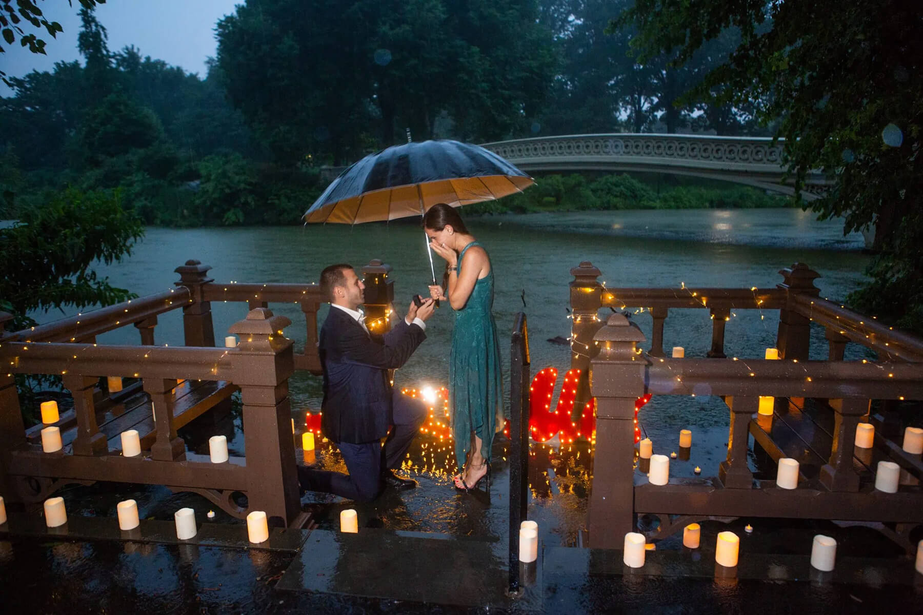 Beautiful candlelight proposal under the rain 3