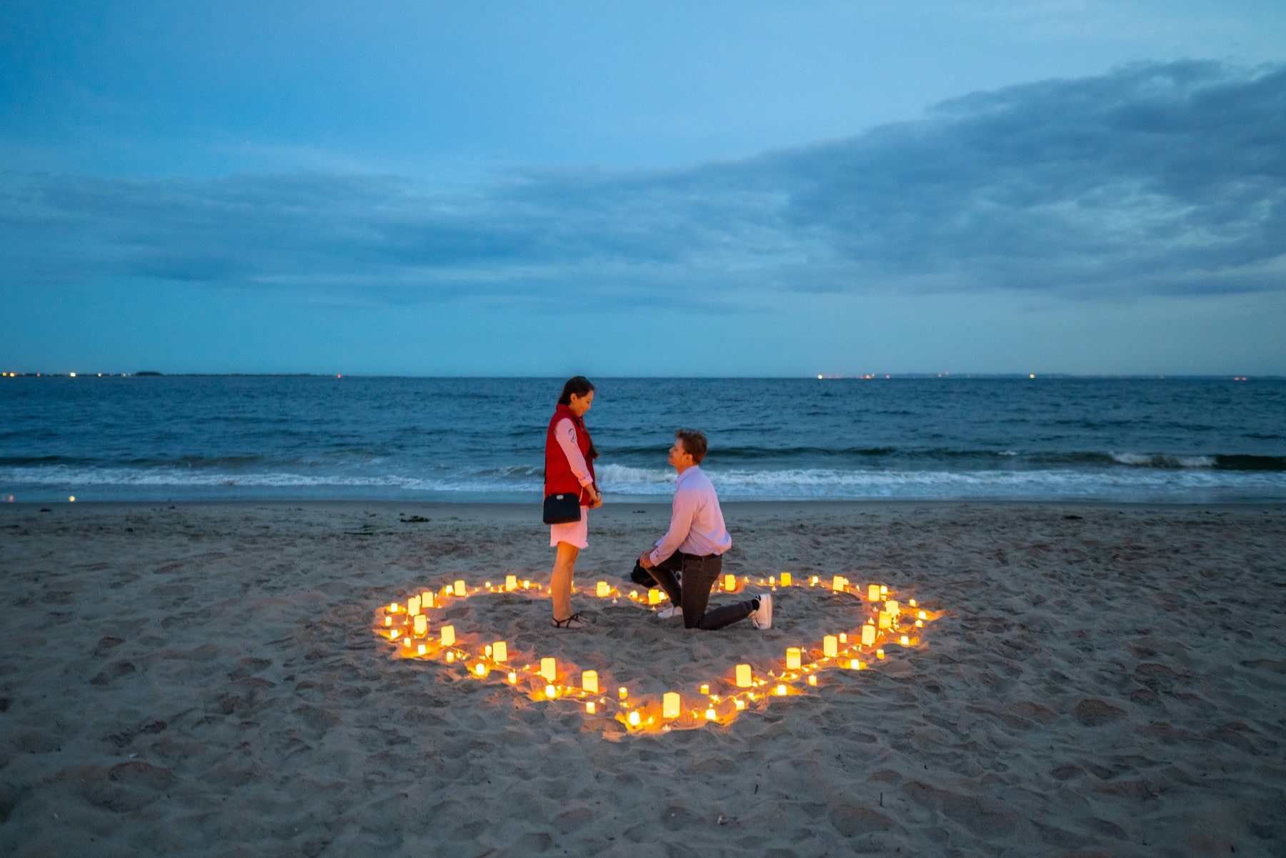 Intimate candlelight proposal on the beach