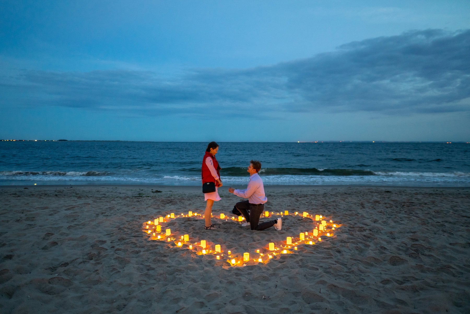 Intimate candlelight proposal on the beach