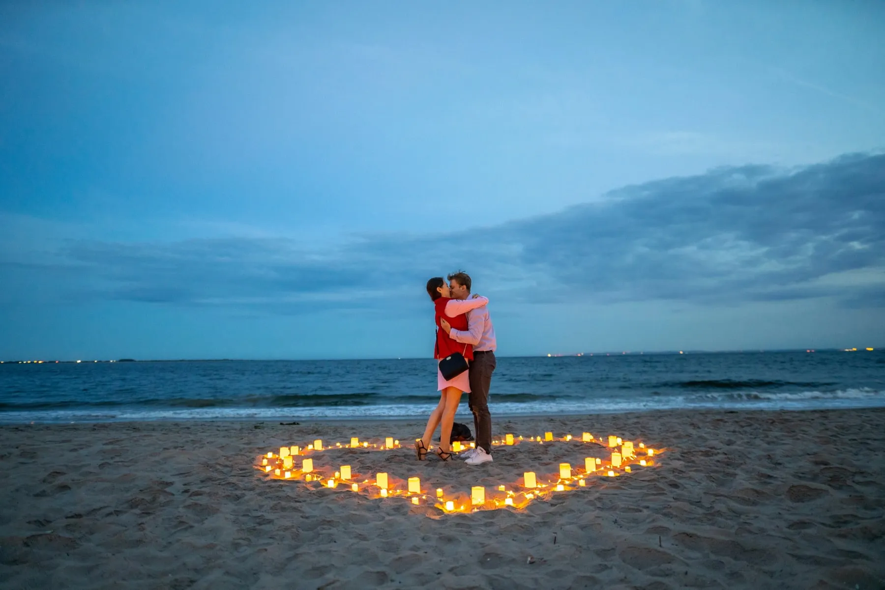Intimate candlelight proposal on the beach
