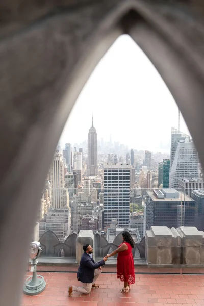 Emotional proposal moment at Top of the Rock with Empire State Building view, perfect NYC engagement spot. Second level of Top Of the Rock